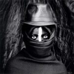 El Anatsui portrait with African mask-like face covering reflecting Yoruba ceremonial traditions