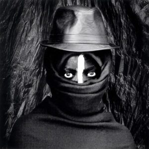 El Anatsui portrait with African mask-like face covering reflecting Yoruba ceremonial traditions