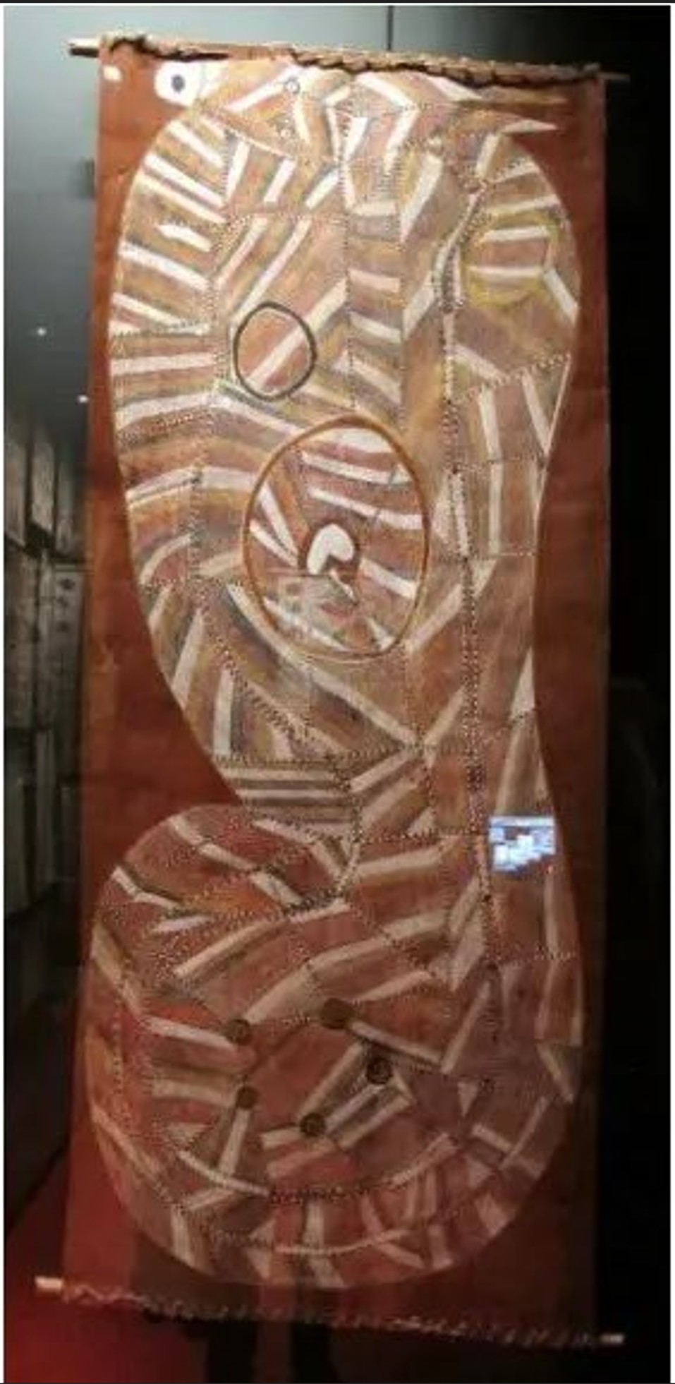 Bronze sculpture featuring interconnected Anishinaabe faces and spirit figures by Norval Morrisseau