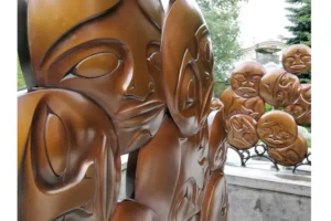 Norval Morrisseau bronze sculpture with interconnected spirit faces in Anishinaabe X-ray style