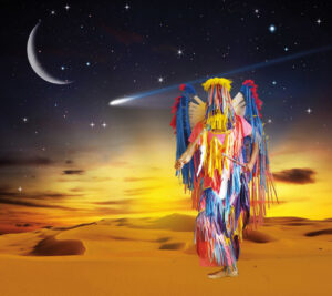 Wendy Red Star photograph featuring Crow Nation ceremonial ribbon dress against surreal desert sky backdrop