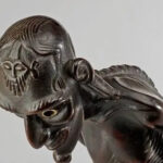 Marquesan tiki sculpture representing Polynesia culture, carved from dark volcanic basalt